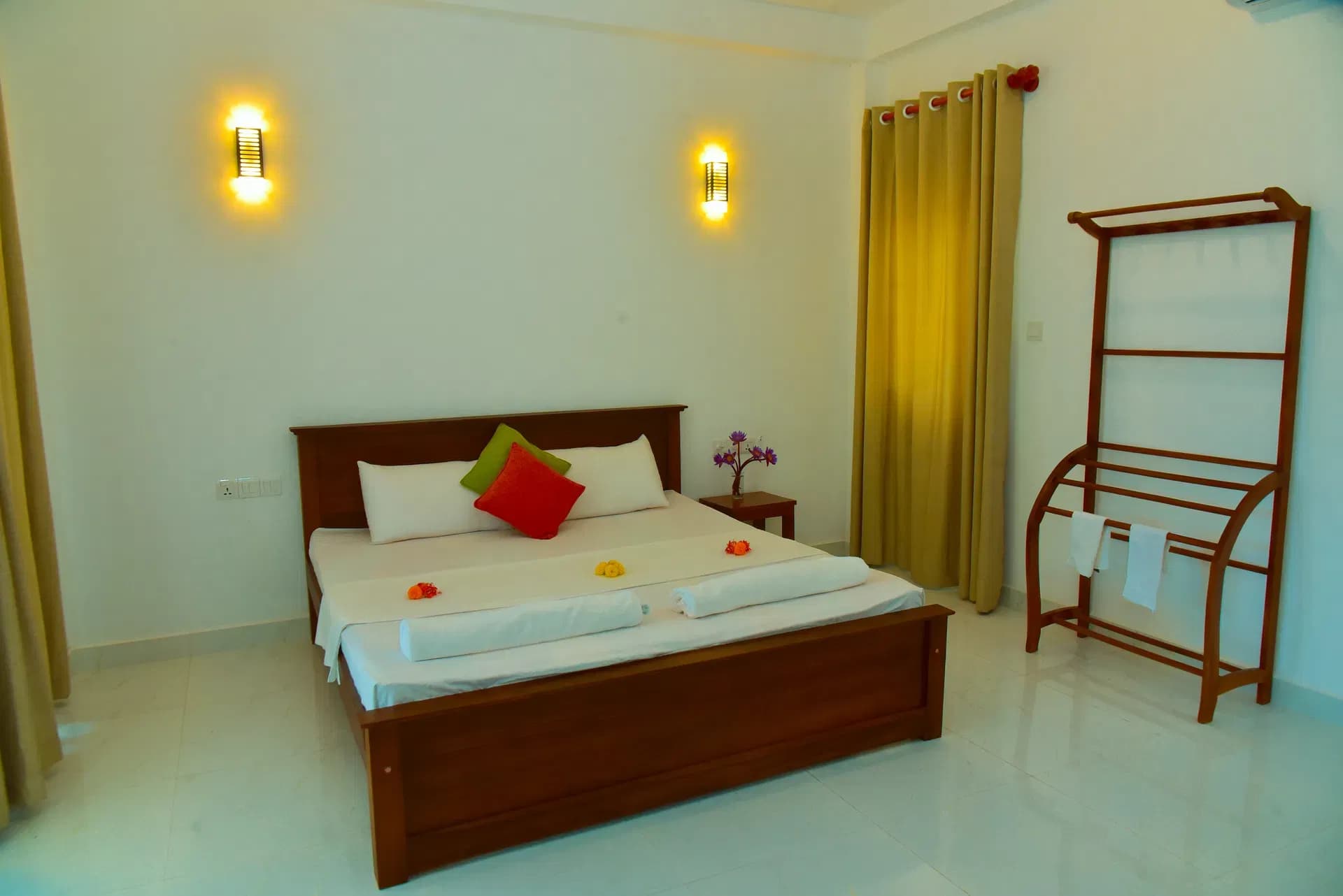 Standard room with cozy bed and wall lamps